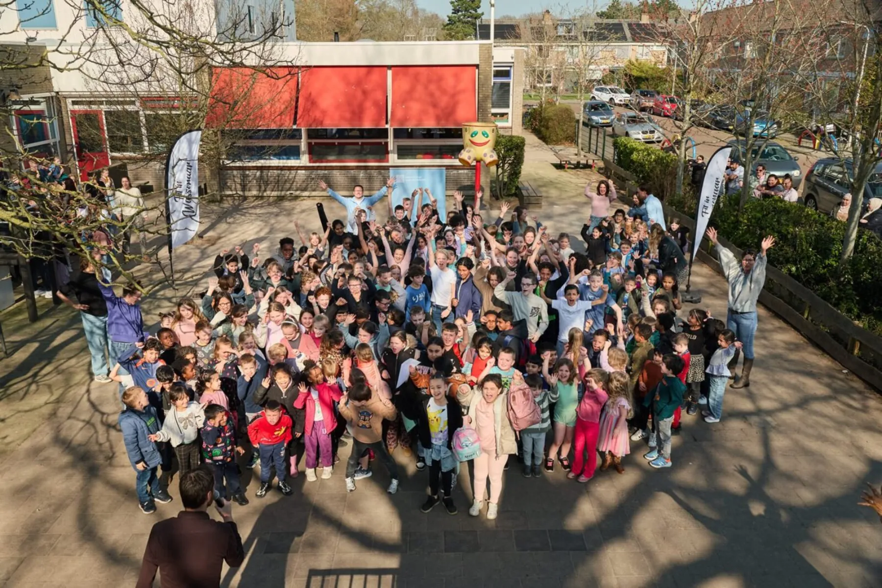 First Lentedag Wassenaar 2026: all pupils gathered on the schoolyard with FiW flags