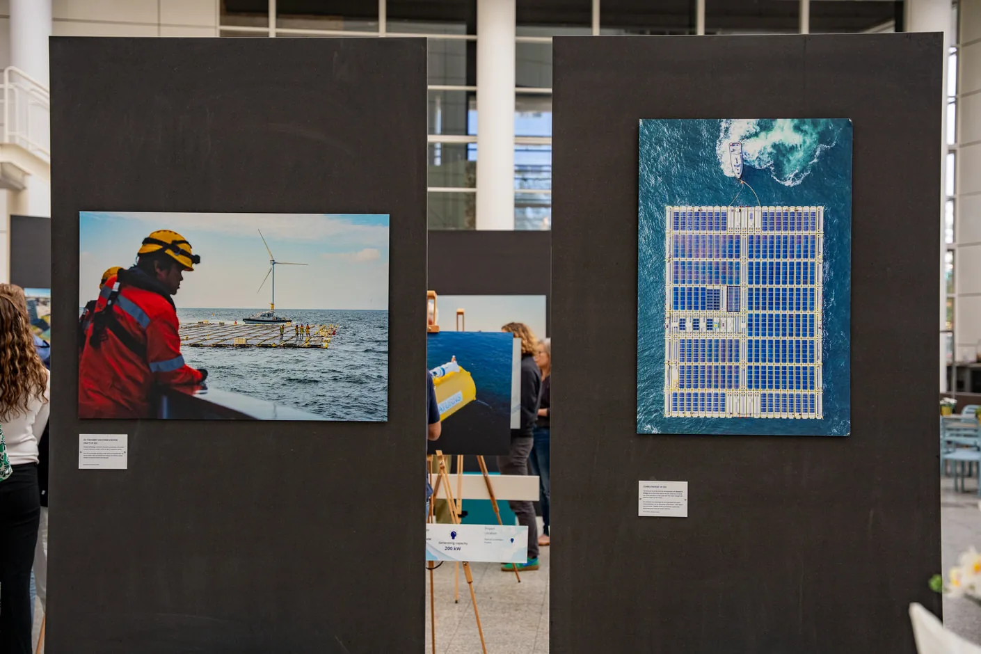 Panels and easels with photographs and captions in the Atrium